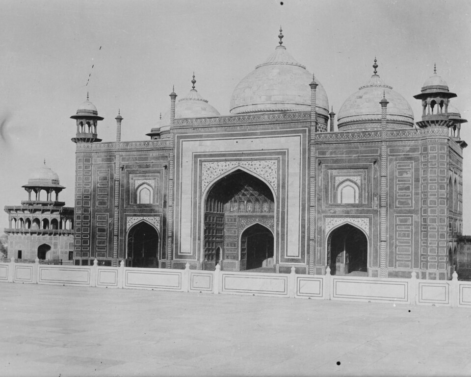 Historic view of the red sandstone Mosque on the western terrace of the Taj Mahal