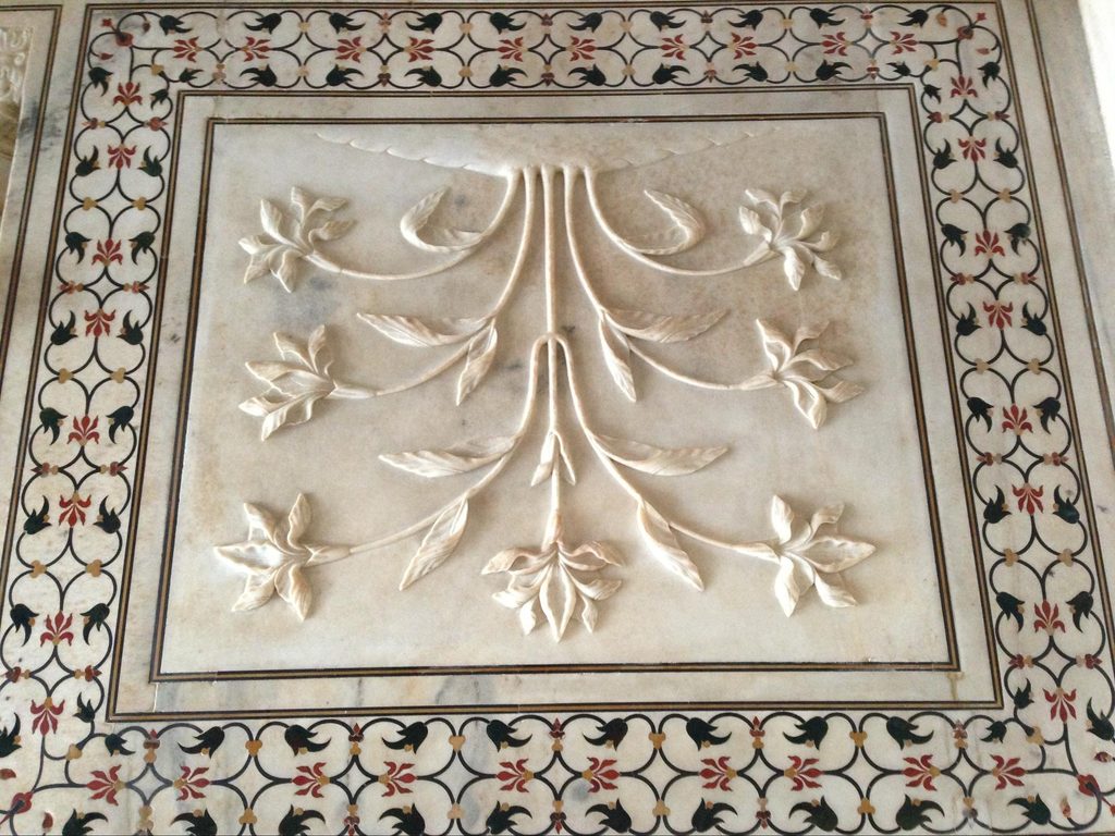 Carved white marble dado panel with intricate pietra dura floral inlay inside the Taj Mahal